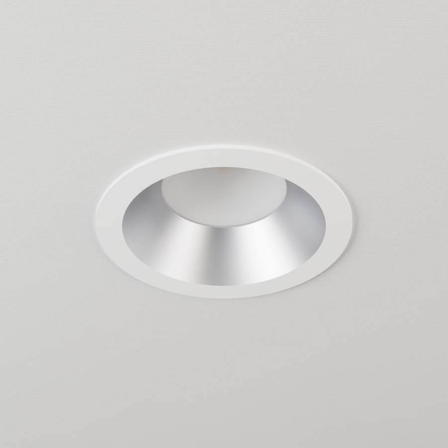DMF Lighting C4TRSSP C-Series 4 inch standard round trim, semi-specular with white flange, shown in ceiling.